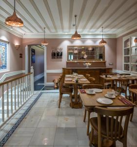 a restaurant with wooden tables and chairs and a staircase at Hotel Turkish House in Istanbul