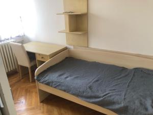 a bedroom with a bed and a desk and a deskablish at Aleksandra in Skopje
