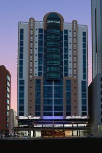 a large building with a train in front of it at Elite Tower in Seef