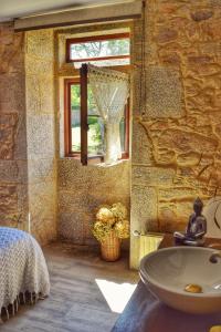 baño con lavabo y ventana en Casa dos Amos en Costa da Morte. A Coruña, en Ponteceso