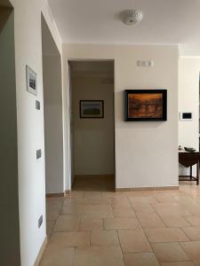 a hallway with white walls and a tile floor at Affittacamere Bellavista in San Marco dei Cavoti