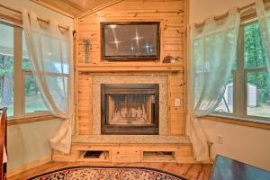 a living room with a fireplace and a tv at Smithville Remote Escape with Furnished Deck! in Smithville