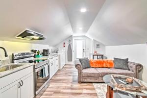 a living room with a couch and a kitchen at Fayetteville Apartment with Yard Pets Welcome! in Fayetteville