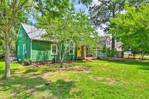 a green house in a yard with trees at Fayetteville Apartment with Yard Pets Welcome! in Fayetteville