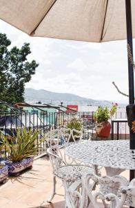 a table and chairs on a patio with a view at Casa Rosa Mexicano in Oaxaca City
