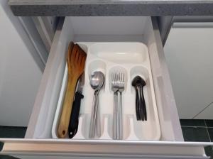 a white tray with utensils in a drawer at OPTIMA COMFORT in Beer Sheva