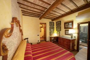 a bedroom with a bed and a bathroom at Degli Alessandri house in Sassoferrato