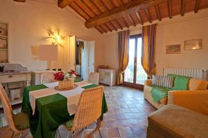 a living room with a table and a couch at Podere Chiaromonte in Palaia