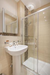 a bathroom with a sink and a glass shower at The Moorland Hotel, Haytor, Devon in Haytor