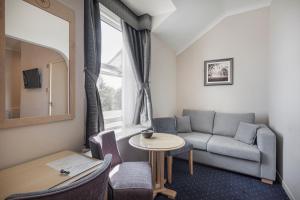 a living room with a couch and a table at The Moorland Hotel, Haytor, Devon in Haytor