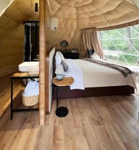 a bedroom with a large bed in a tent at Domes Town by ANGAR in Vahagnadzor