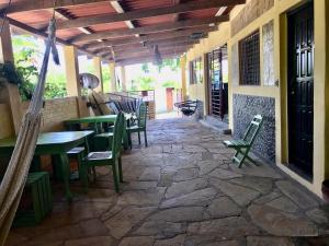 un patio con mesa y sillas en un suelo de piedra en Bananoz Surfhouse, en Transito