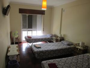 A bed or beds in a room at Homestay Marialva Park