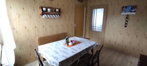 a dining room with a table with chairs and a window at Ubytování Ostrov u Macochy in Ostrov u Macochy