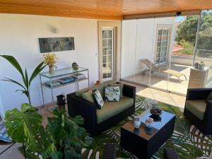 uma sala de estar com um sofá e uma mesa em Villa Casa Dina em Casal da Lagoa Seca