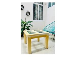 a yellow table and a chair in a room at Hotel Ocean Huatulco in Santa Cruz Huatulco