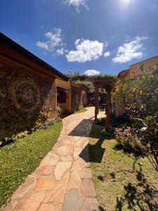 a stone walkway next to a building with at Hospedaria Vila Khepri in Gonçalves +60 photos