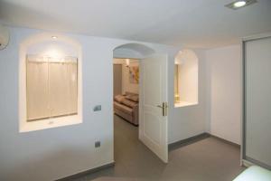 a white room with a door and a couch at Kafenes Home in Mesaria