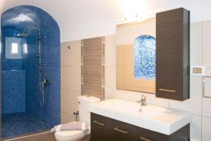 a bathroom with a sink and a toilet and a shower at Kafenes Home in Mesaria +19 photos