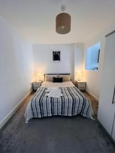 a bedroom with a large bed with two night stands at Cotton Apartment Chinatown Central Stay in Birmingham