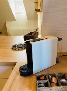 a toaster sitting on a counter next to a box of donuts at Le Loft in Colmar