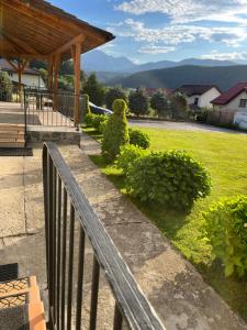 a wooden fence in front of a yard with a park at Pensiunea Funivia in Săcele