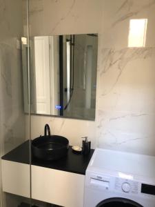 a bathroom with a sink and a washing machine at Arc de triomphe, Champs Elysées, Foch Avenue Luxury apartment in Paris
