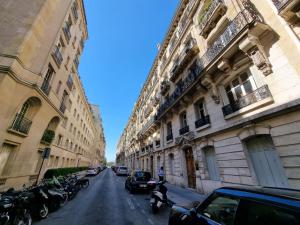 a street with cars parked on the side of buildings at Arc de triomphe, Champs Elysées, Foch Avenue Luxury apartment in Paris