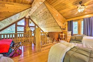 a bedroom in a log cabin with two beds at Rustic Hideaway Fire Pits, Grills, 87 Acres! 