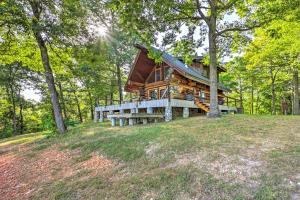 a log cabin in the woods with a roof at Rustic Hideaway Fire Pits, Grills, 87 Acres! 