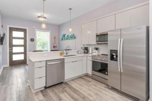 a kitchen with white cabinets and a stainless steel refrigerator at Nashville 3 Bed, 1 Bedroom with Washer, Dryer and Parking in Nashville