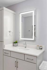 a white bathroom with a sink and a mirror at Nashville 3 Bed, 1 Bedroom with Washer, Dryer and Parking in Nashville