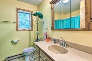 a bathroom with a sink and a toilet and a mirror at Lakefront Spicer Cabin with Dock and 2 Kayaks! in Spicer +36 photos