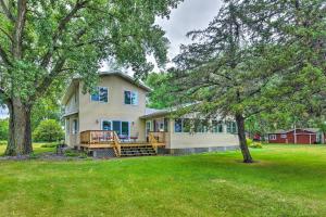 a house with a large yard with a porch at Lakefront Spicer Cabin with Dock and 2 Kayaks! in Spicer