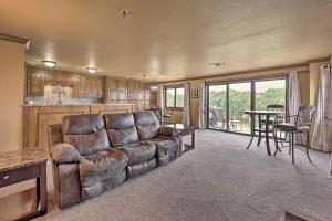 a living room with a couch and a table at Cozy Afton Condo with Golf Course and Lake Views! in Afton
