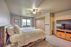 a bedroom with a bed and a flat screen tv at Cozy Afton Condo with Golf Course and Lake Views! in Afton