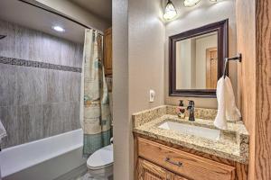 a bathroom with a sink and a toilet and a mirror at Golf Course and Lake Views Cozy Afton Condo! in Afton +23 photos
