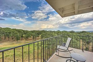 a balcony with two chairs and a view of the woods at Cozy Afton Condo with Golf Course and Lake Views! in Afton