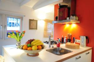 a kitchen with a sink and a bowl of fruit at Pantheos Top Houseboat in Amsterdam