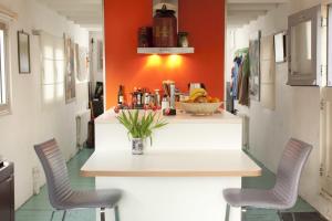 a kitchen with a table and two chairs at Pantheos Top Houseboat in Amsterdam