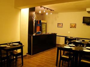 a restaurant with tables and chairs in a room at Koten Hotel in Buenos Aires