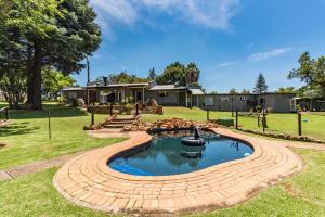 a pool in a yard with a house in the background at Self-Catered Apartment With Pool in Krugersdorp