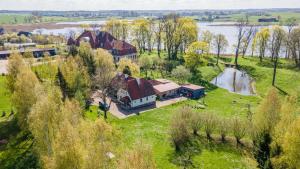 an aerial view of a house on a field with a river at Dom Ogrodnika in Biała Olecka