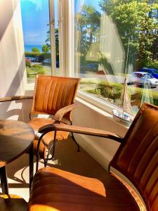 two chairs and a table in front of a window at White Gable in Scarborough