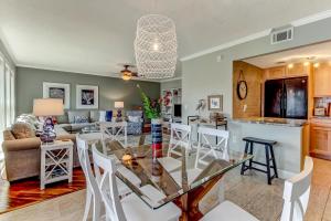 a kitchen and living room with a glass table and chairs at Walk to Beach-Fernandina Shores 6513-Pool & Tennis-On North End Near Main Beach in Fernandina Beach