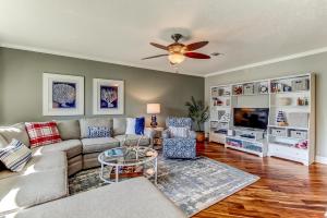 a living room with a couch and a ceiling fan at Walk to Beach-Fernandina Shores 6513-Pool & Tennis-On North End Near Main Beach in Fernandina Beach