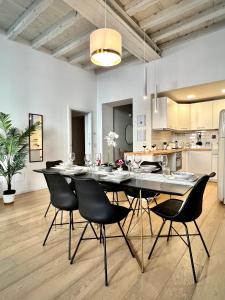 a dining room and kitchen with a table and chairs at Art of living [Luxury House in Como] in Como