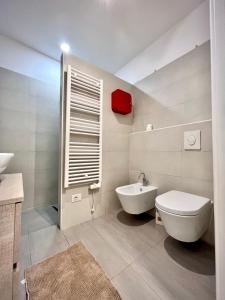 a bathroom with a white toilet and a sink at Art of living [Luxury House in Como] in Como