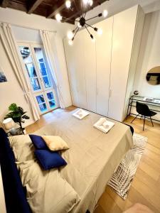 a room with a large bed with blue pillows on it at Art of living [Luxury House in Como] in Como