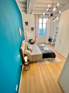 a bedroom with a bed and a blue wall at Art of living [Luxury House in Como] in Como